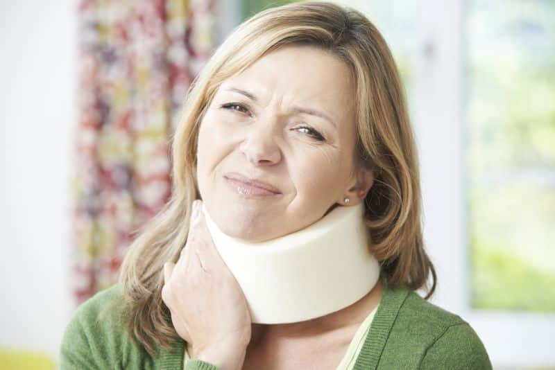 Woman Wearing Surgical Collar In Pain